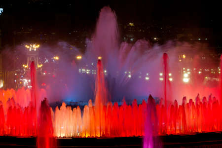BARCELONA - JULY 25: Tourists at the Magic Fountain of Montjuïc (Font màgica de Montjuïc) and Palau Nacional on the Montjuïc, near Plaça d'Espanya on July 25, 2011 in Barcelona, Spainのeditorial素材