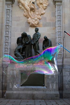 BARCELONA - MAY 14  Unknown street artist making giant soap bubbles and children playing with them...