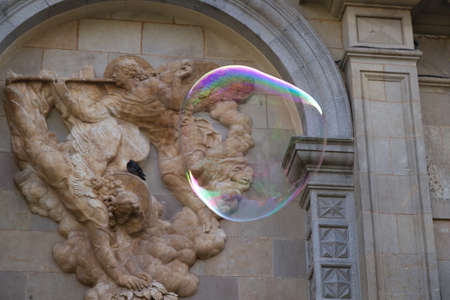 BARCELONA - MAY 14  Unknown street artist making giant soap bubbles and children playing with them...