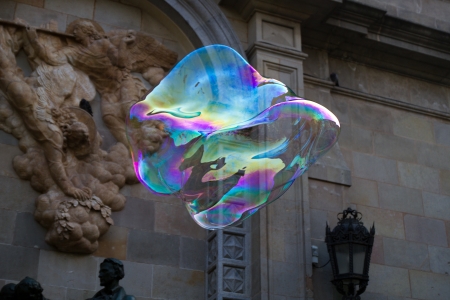 BARCELONA - MAY 14  Unknown street artist making giant soap bubbles and children playing with them on May 14, 2012 in Barcelona, Spainのeditorial素材