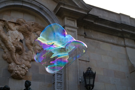 BARCELONA - MAY 14  Unknown street artist making giant soap bubbles and children playing with them on May 14, 2012 in Barcelona, Spainのeditorial素材