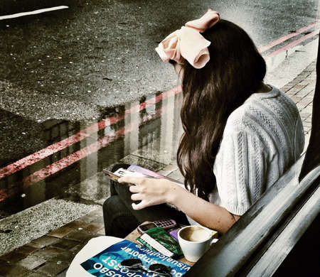 Lady in front of coffee shop in London