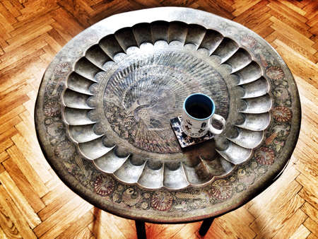 Round beautiful design table with coffee cupの素材