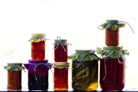 Rustic jars of home made delicacies  marmalade and pickles の写真素材