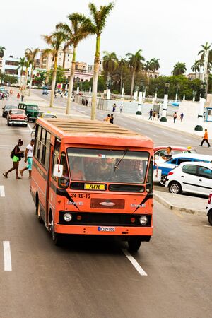 HAVANA - APRIL 27, 2016: People, cars and buildings in Old Havana (Havana Vieja)