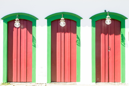 Typical historical buildings with colorful wooden doors and windows in the colonial downtown of Paraty, Rio de Janeiro, Brazil on March 27th, 2016.の写真素材