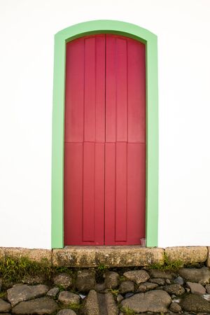 Typical historical buildings with colorful wooden doors and windows in the colonial downtown of Paraty, Rio de Janeiro, Brazil on March 27th, 2016.の写真素材