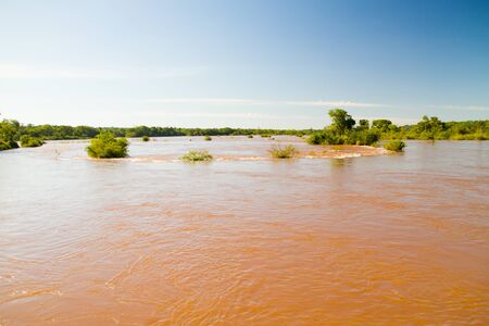 View of the Iguazu Iguacu) falls, the largest series of waterfalls on the planet, located between Brazil, Argentina, and Paraguay. At some times during the year one can see as many as 275 separate waterfalls cascading along the edges of 2,700 meters (1.6 の写真素材