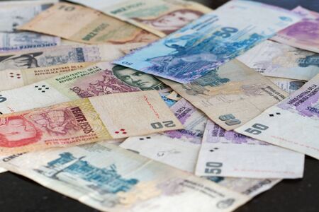 Colorful background of mixed banknotes of south and central american currenciesの写真素材