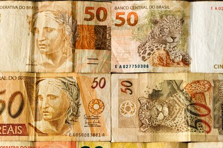 Colorful background of mixed banknotes of south and central american currenciesの写真素材
