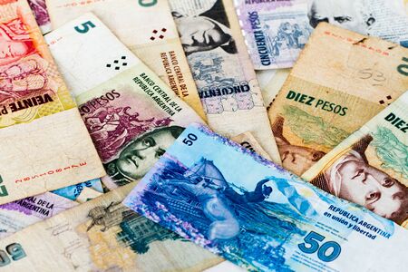 Colorful background of mixed banknotes of south and central american currenciesの写真素材