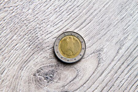Mix of euros and cents on wooden background