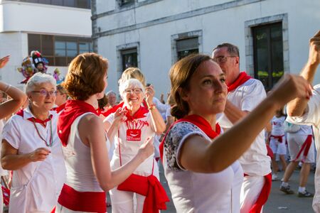 BAYONNE, FRANCE - JULY31: Unknown people dresses in traditional red and white clothes enjoying the "Fetes de Bayonne" festivals in the Northern Basque Country in the town of Bayonne, France on July 31st, 2017のeditorial素材