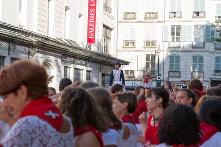BAYONNE, FRANCE - JULY31: Unknown people dresses in traditional red and white clothes enjoying the "Fetes de Bayonne" festivals in the Northern Basque Country in the town of Bayonne, France on July 31st, 2017のeditorial素材