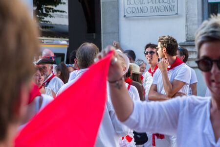 BAYONNE, FRANCE - JULY31: Unknown people dresses in traditional red and white clothes enjoying the "Fetes de Bayonne" festivals in the Northern Basque Country in the town of Bayonne, France on July 31st, 2017のeditorial素材