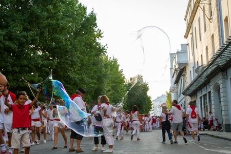 BAYONNE, FRANCE - JULY31: Unknown people dresses in traditional red and white clothes enjoying the "Fetes de Bayonne" festivals in the Northern Basque Country in the town of Bayonne, France on July 31st, 2017のeditorial素材