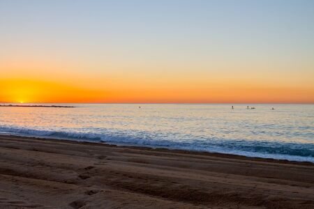 Barceloneta Beach in Barcelona with colorful sky at sunriseの写真素材