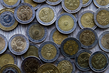 Pile of coins on wooden backgroundの写真素材