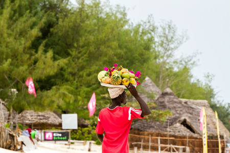 ZANZIBAR, TANZANIA - JANUARY 05: Unknown Zanzibar beach fruits seller in on Paje beach, Zanzibar, Tanzania on January 5th, 2018のeditorial素材