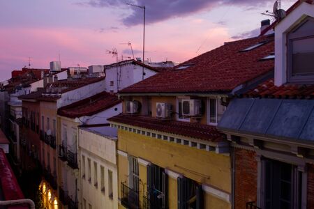 View of Madrid rooftops at sunset with hues of yellow and purple in the skyの写真素材