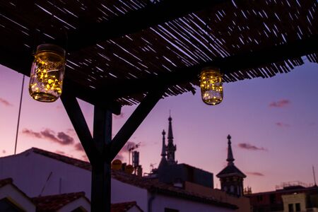 View of Madrid rooftops at sunset with hues of yellow and purple in the skyの写真素材