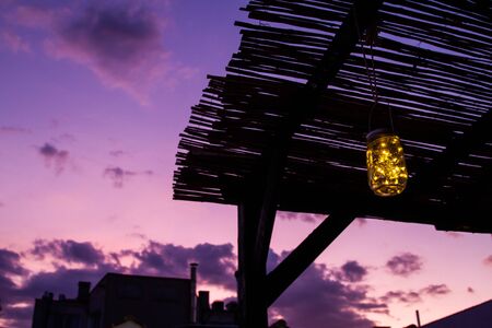 View of Madrid rooftops at sunset with hues of yellow and purple in the skyの写真素材