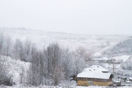 Image of white winter landscape during snowfall in rural setting in Decemberの写真素材