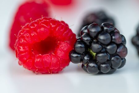 Berries - strawberries, raspberries, blueberries, blackberries - on white background in natural...