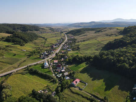 Aerial view of rural Romania, with houses, lakes, green forest and fieldsの写真素材