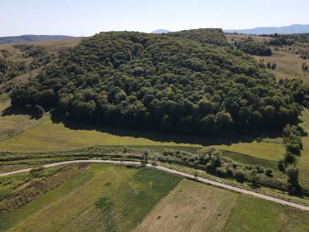 Aerial view of rural Romania, with houses, lakes, green forest and fieldsの写真素材