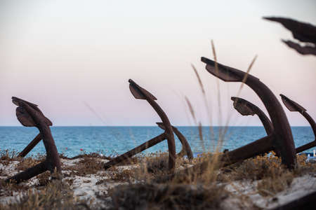 The arrangement of anchors memorial to the lost tuna fishing industry that once thrived there and were used to keep the nets in place as opposed to mooring the boats at the Anchor Graveyard in Praia do Barril, Tavira, Portugalの写真素材