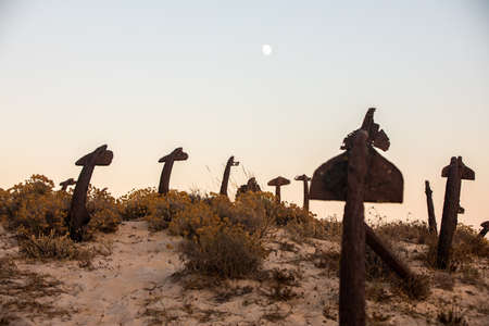 The arrangement of anchors memorial to the lost tuna fishing industry that once thrived there and were used to keep the nets in place as opposed to mooring the boats at the Anchor Graveyard in Praia do Barril, Tavira, Portugalの写真素材