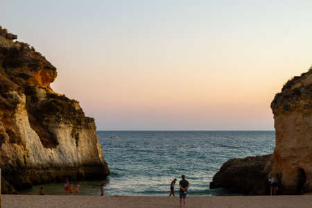 Algarve, Portugal - August 20, 2021: Unknown people on the beach enjoying the beautiful Atlantic coast  in summertime in serene landscape of Algarve, Portugal in August 2021のeditorial素材