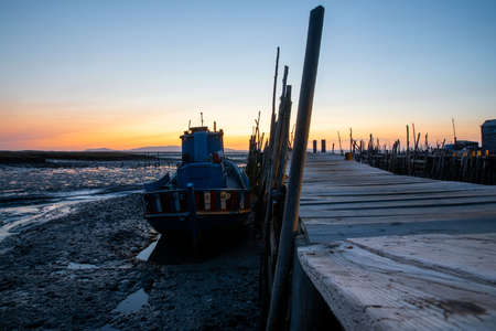 Porto Palafita da Carrasqueira, known as âCais Palafitico da Carrasqueiraâ or âCarrasqueira Palafitic Pierâ, interlocking pier on wooden stilts, built by fishermen in the 60âs, in Portugal, at sunsetのeditorial素材