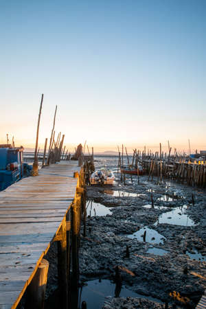 Porto Palafita da Carrasqueira, known as âCais Palafitico da Carrasqueiraâ or âCarrasqueira Palafitic Pierâ, interlocking pier on wooden stilts, built by fishermen in the 60âs, in Portugal, at sunsetのeditorial素材