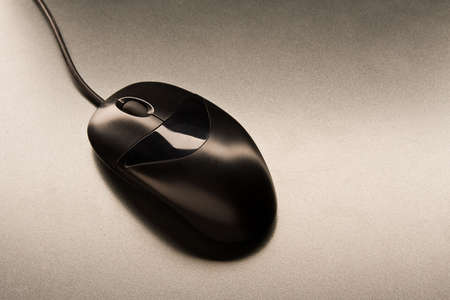 The computer mouse black color lay on a grey table