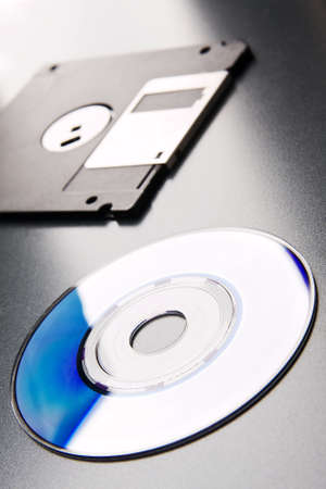 CD lays on a background floppy disk