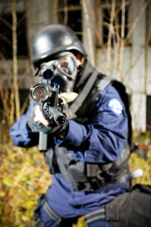 The armed soldier in a camouflage costs in alertness