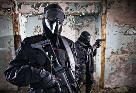 The two armed soldiers in a camouflage costs in alertnessの写真素材