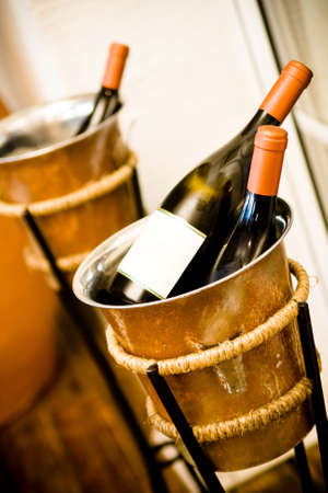 Two bottles of champagne are in a bucket with iceの写真素材