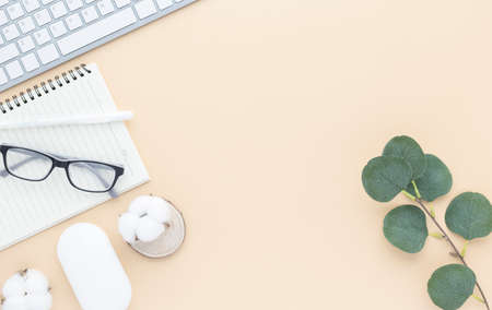Office desk table top view with office supply, Beige table with copy space, Beige color workplace composition, flat layの写真素材