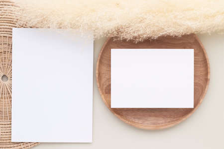 Blank paper cards, Mockup with pampas grass on a wooden plate, beige background, Minimal beige workplace composition, flat lay, mockupの写真素材