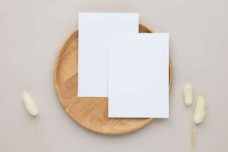 Blank paper cards, Greeting card Mockup with pampas grass on a wooden plate, beige background,...