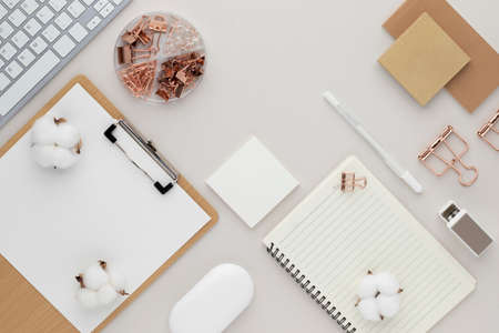 Office desk table top view with office supply, beige table with copy space, beige color workplace...