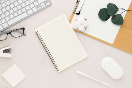 Office desk table top view with office supply, beige table with copy space, beige color workplace...