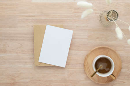 Blank paper card, greeting card mock up. decoration with dried Bunny Tail, Front view, Beautiful Bunny Tail grass in vase on wood table and beige cement wall backgroundの写真素材