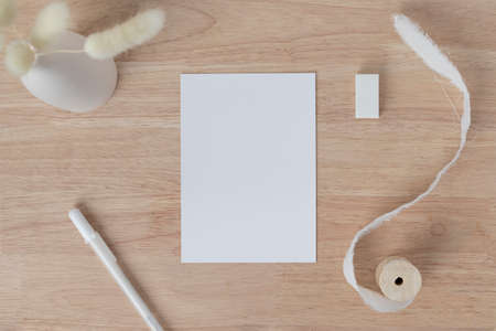 Blank greeting card invitation Mockup 5x7 on Brown envelope with dried flowers on beige background,...