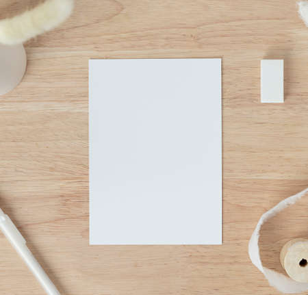 Blank paper on a wooden background. Template for branding identity.の写真素材