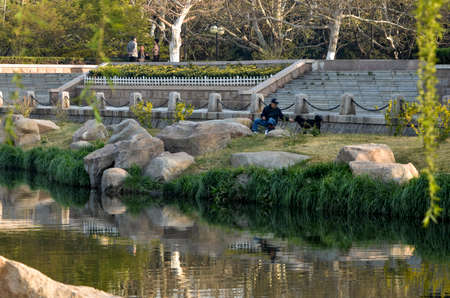 Old man feeding a dogのeditorial素材