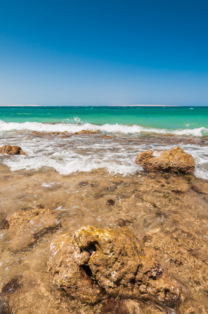 Beautiful azure red sea with waves and rocks and clear blue sky in Egyptの写真素材